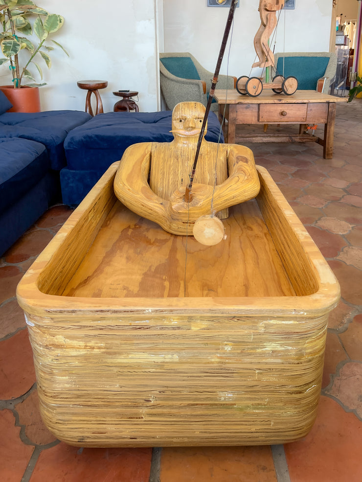 Wooden Man Fishing in a Bathtub by Hy Farber